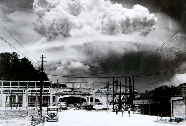 A mushroom cloud from an atomic bomb rises over Nagasaki.