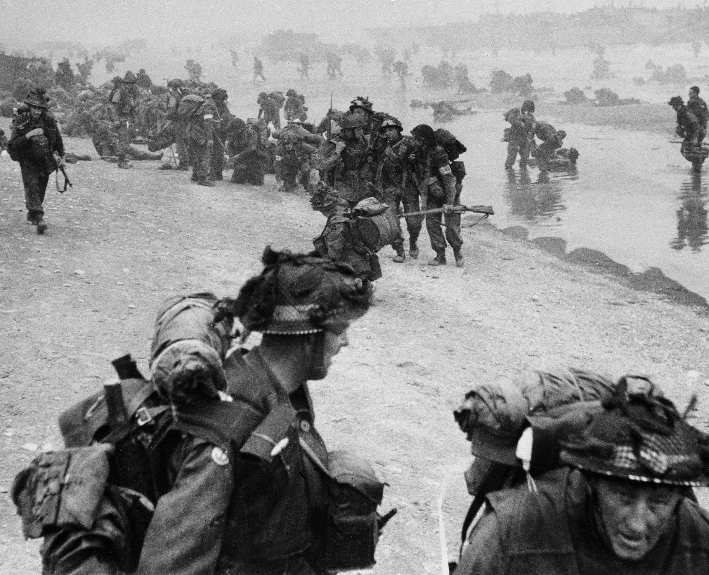 Troops pour ashore during the D Day invasion.